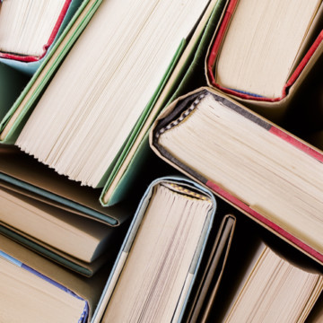 High angle view of many hardback books. Library or school.