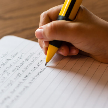 Close-up,Of,Human,Hand,With,Refillable,Pencil,Writing,English,Words